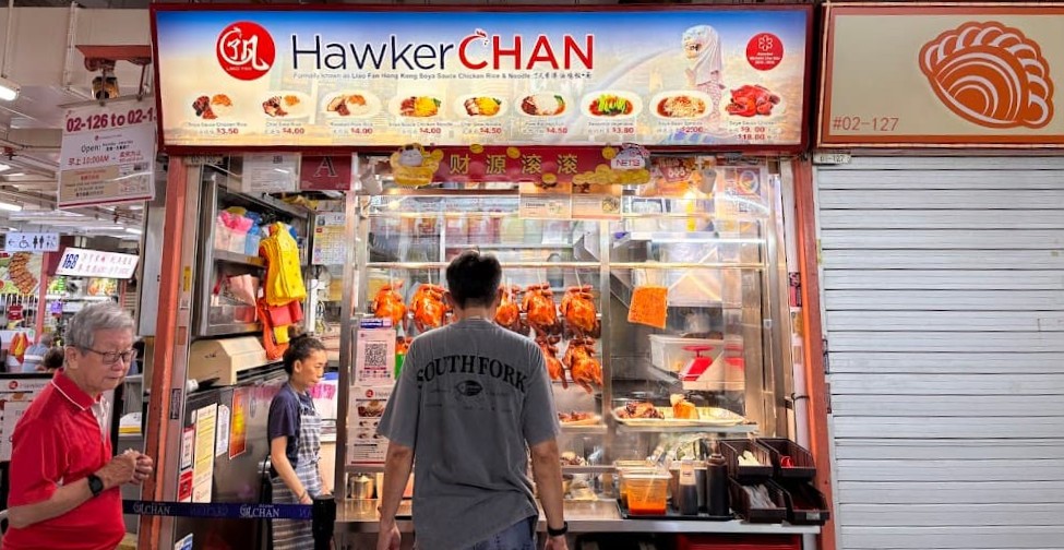 HawkerChan char siew rice stall front in Chinatown, Singapore, with roasted meats on display