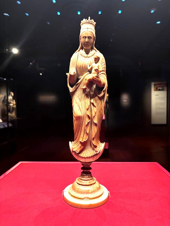 A carved Madonna and Child statue on a gilded base, on display at the Asian Civilisations Museum Singapore.