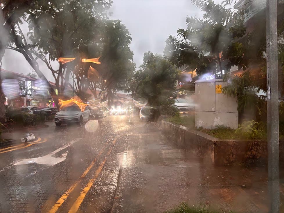 Rainy day in Singapore with heavy tropical rainfall on city streets