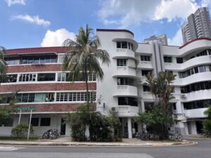 View of Block 78 Moh Guan Terrace in Tiong Bahru showing the contrast between the full brick block and the white curved Streamline Moderne architecture along Moh Guan Terrace Singapore