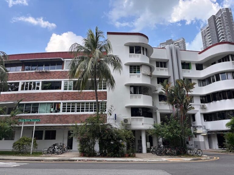 View of Block 78 Moh Guan Terrace in Tiong Bahru showing the contrast between the full brick block and the white curved Streamline Moderne architecture along Moh Guan Terrace Singapore