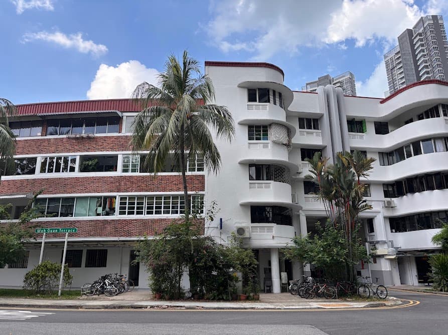 View of Block 78 Moh Guan Terrace in Tiong Bahru showing the contrast between the full brick block and the white curved Streamline Moderne architecture along Moh Guan Terrace Singapore
